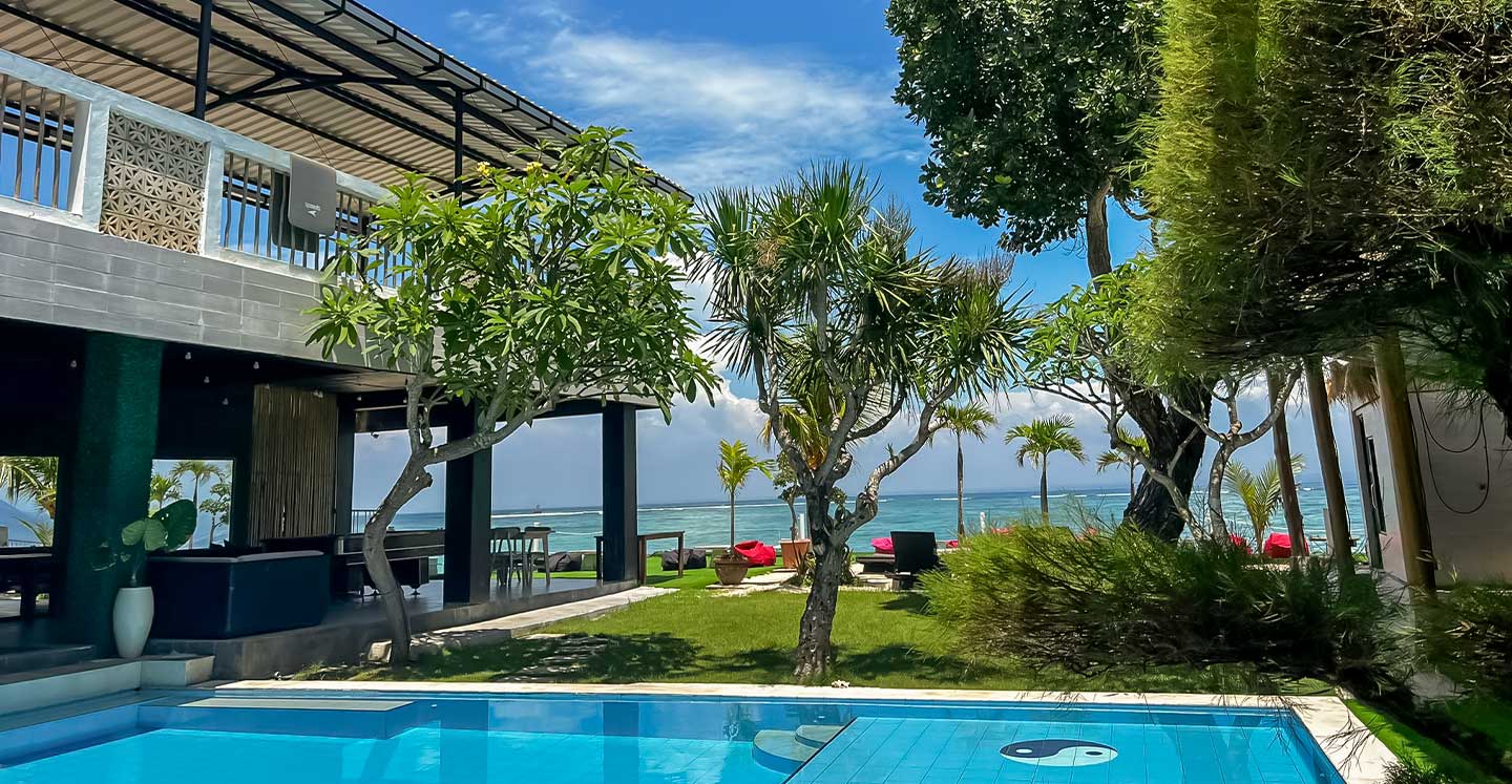 Daytime courtyard pool and ocean view at 3 Monkeys Beach Club