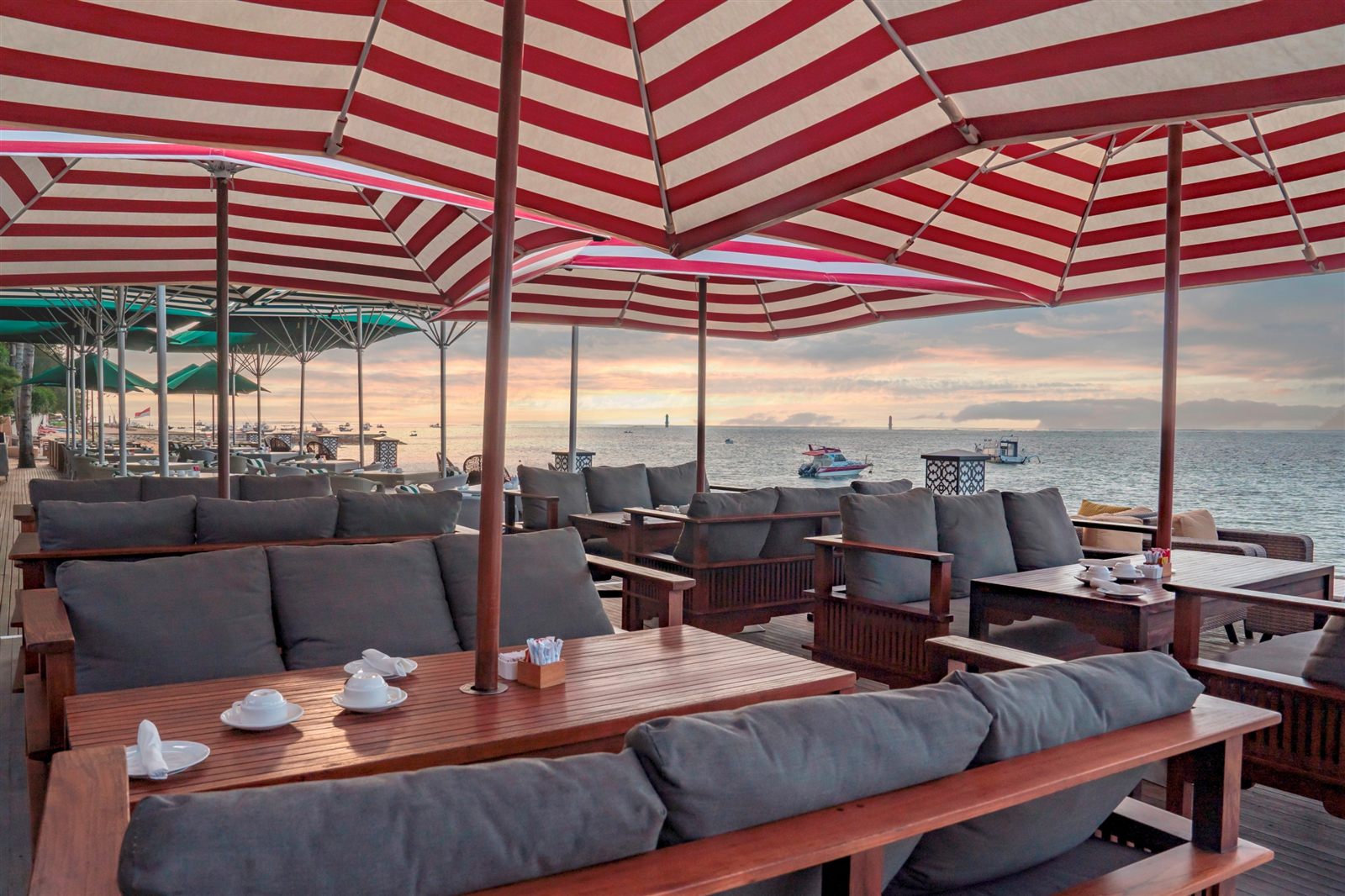 Ocean-facing table setting at Beach Club Restaurant Sanur