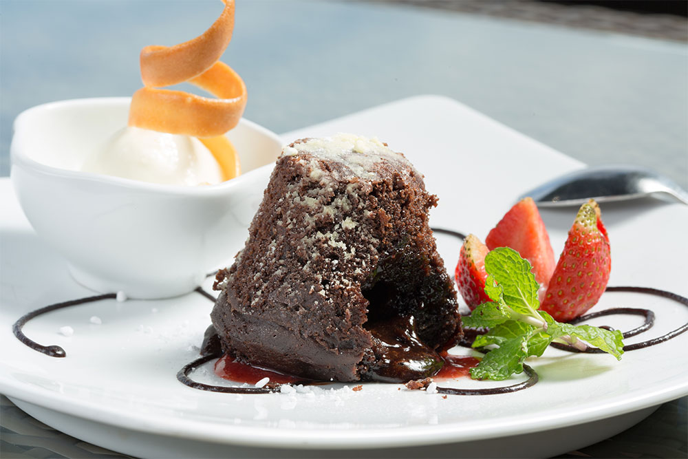 Warm chocolate dessert with ice cream and strawberries