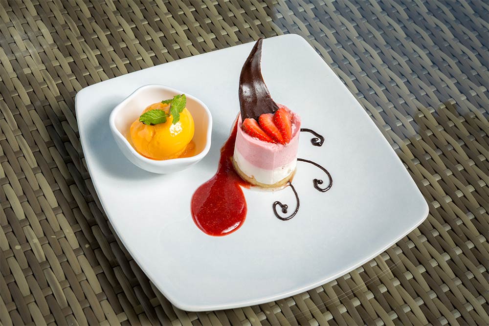 Strawberry mousse and mango ice cream dessert plate