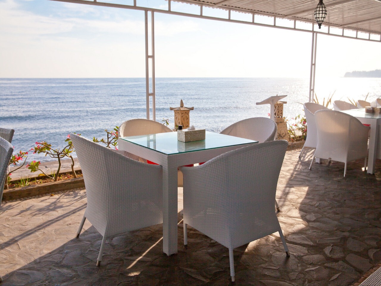 Restaurant tables overlooking the ocean at Bondalem Beach Club