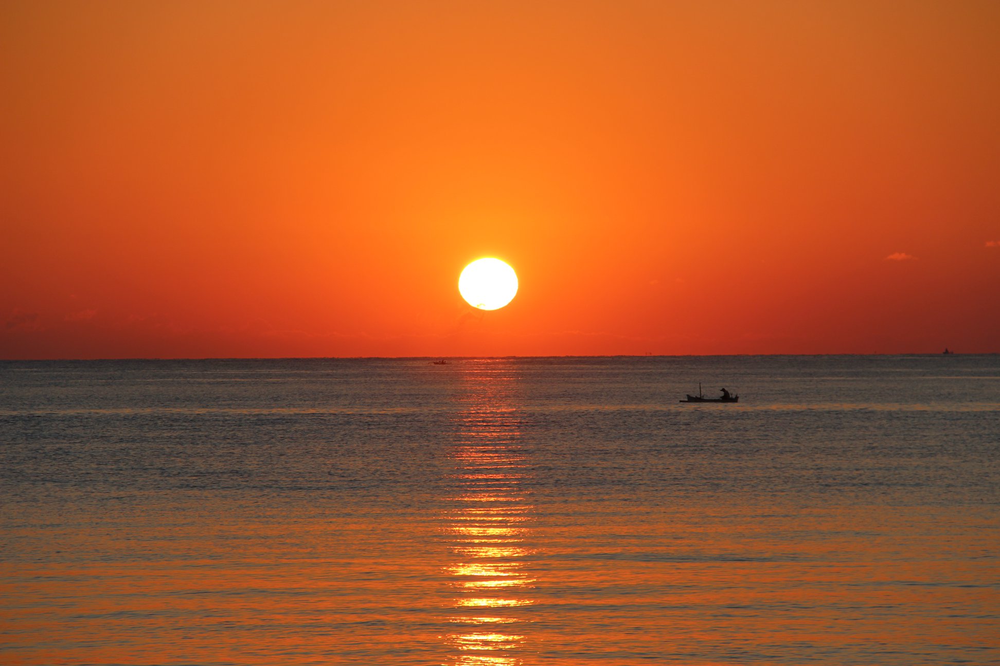 Oceanfront at Bondalem Beach Club beneath an orange sky