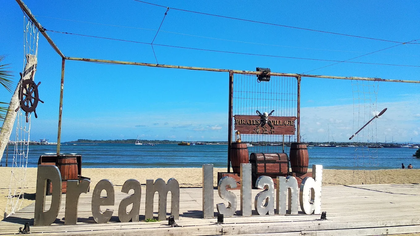 Dream Island sign on the beachfront sand