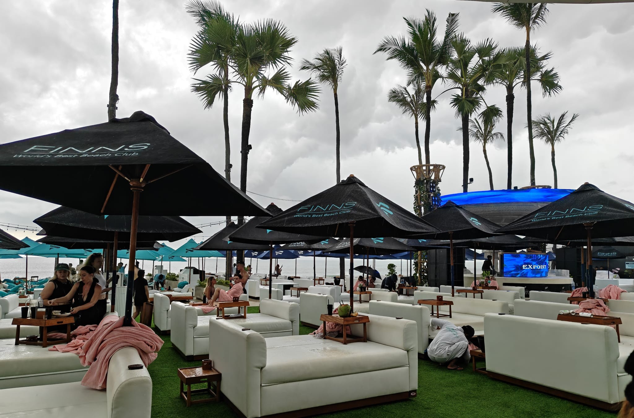 Rainy-day poolside view at FINNS Beach Club.