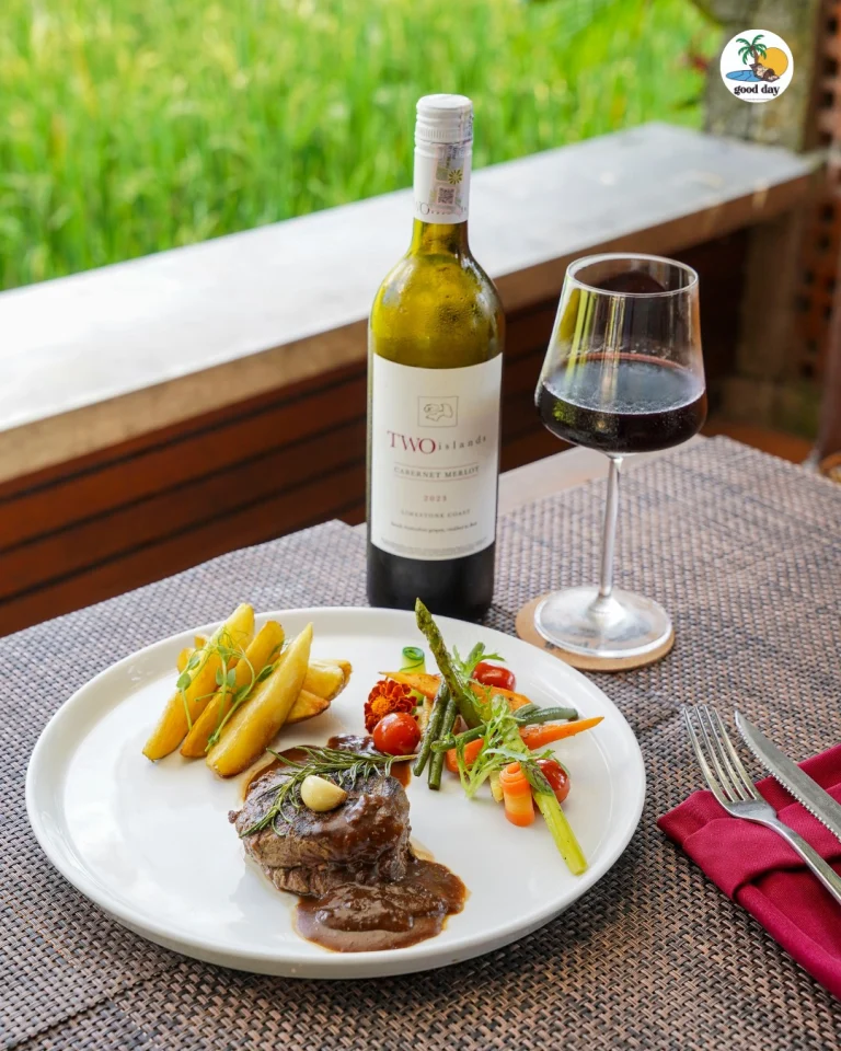 Dish and wine overlooking rice fields at Good Day Ubud