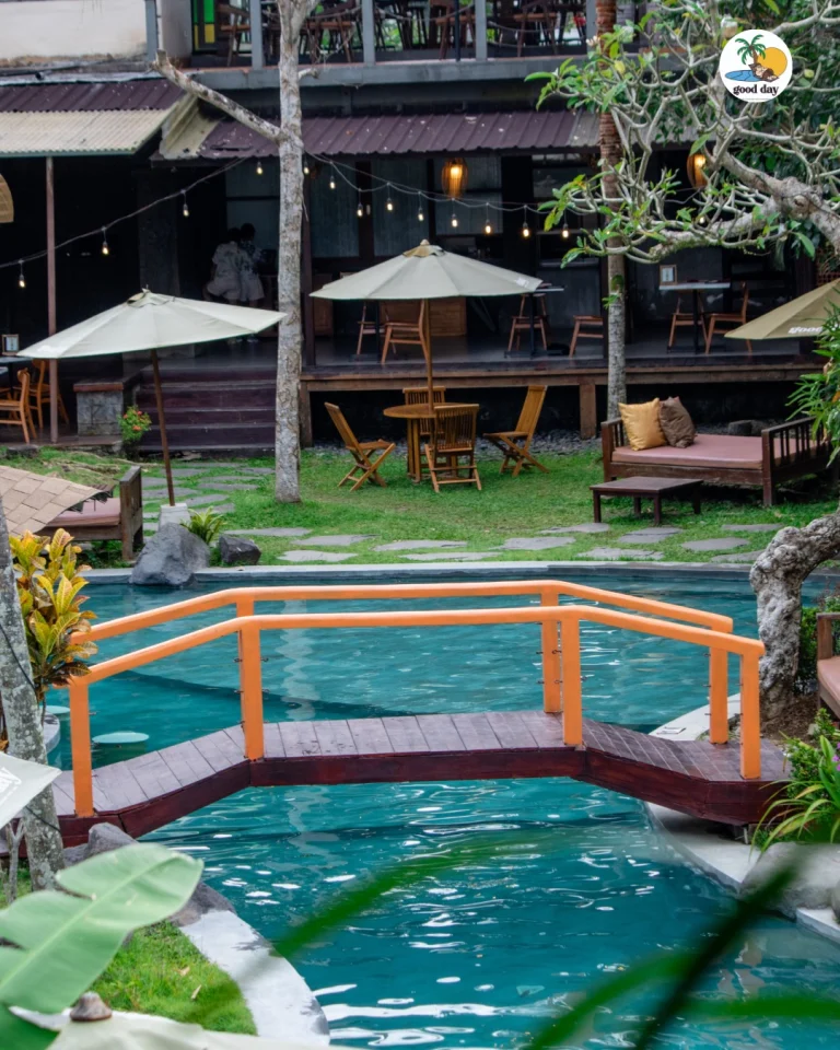 Pool, orange bridge, restaurant deck and seating at Good Day Ubud