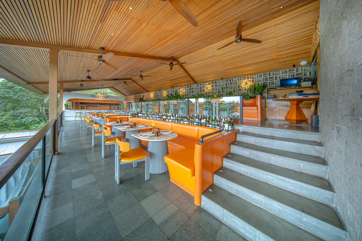 Dining interior with orange seating at Habitat Bistro Ubud
