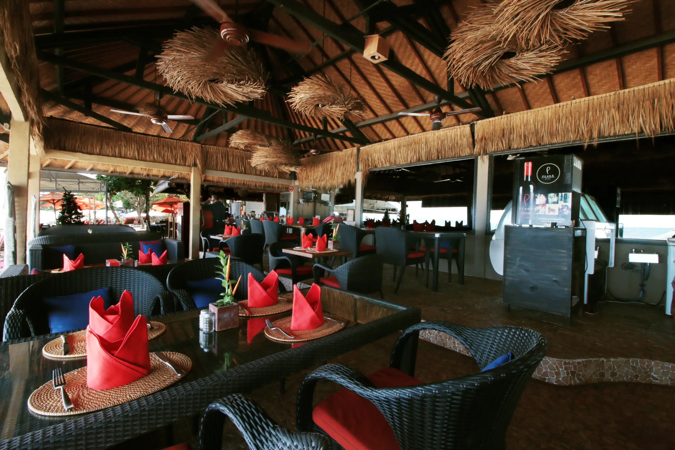 Open-air restaurant seating at Kupu Kupu Jimbaran Beach Club
