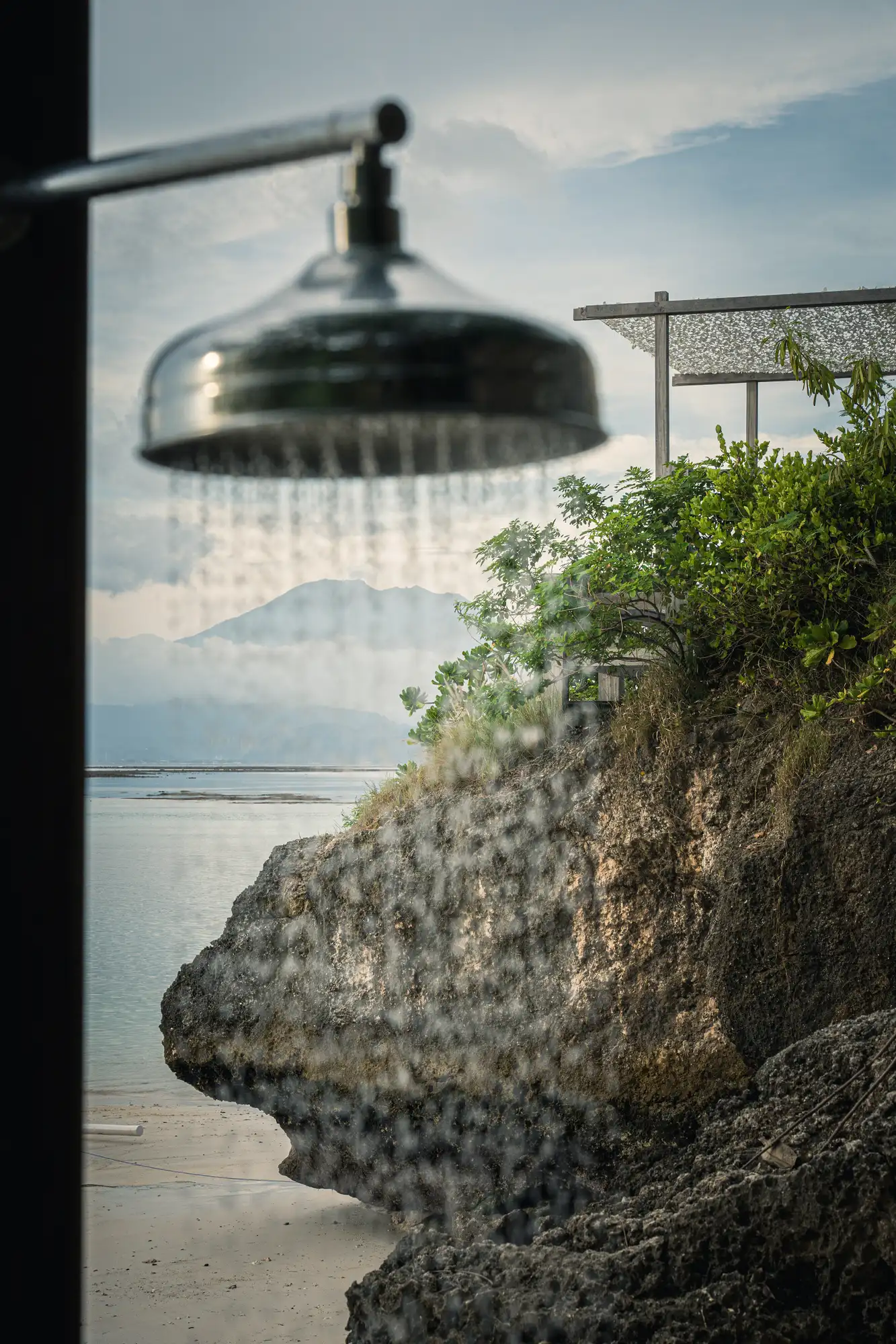 Shower and rocks beside the sea