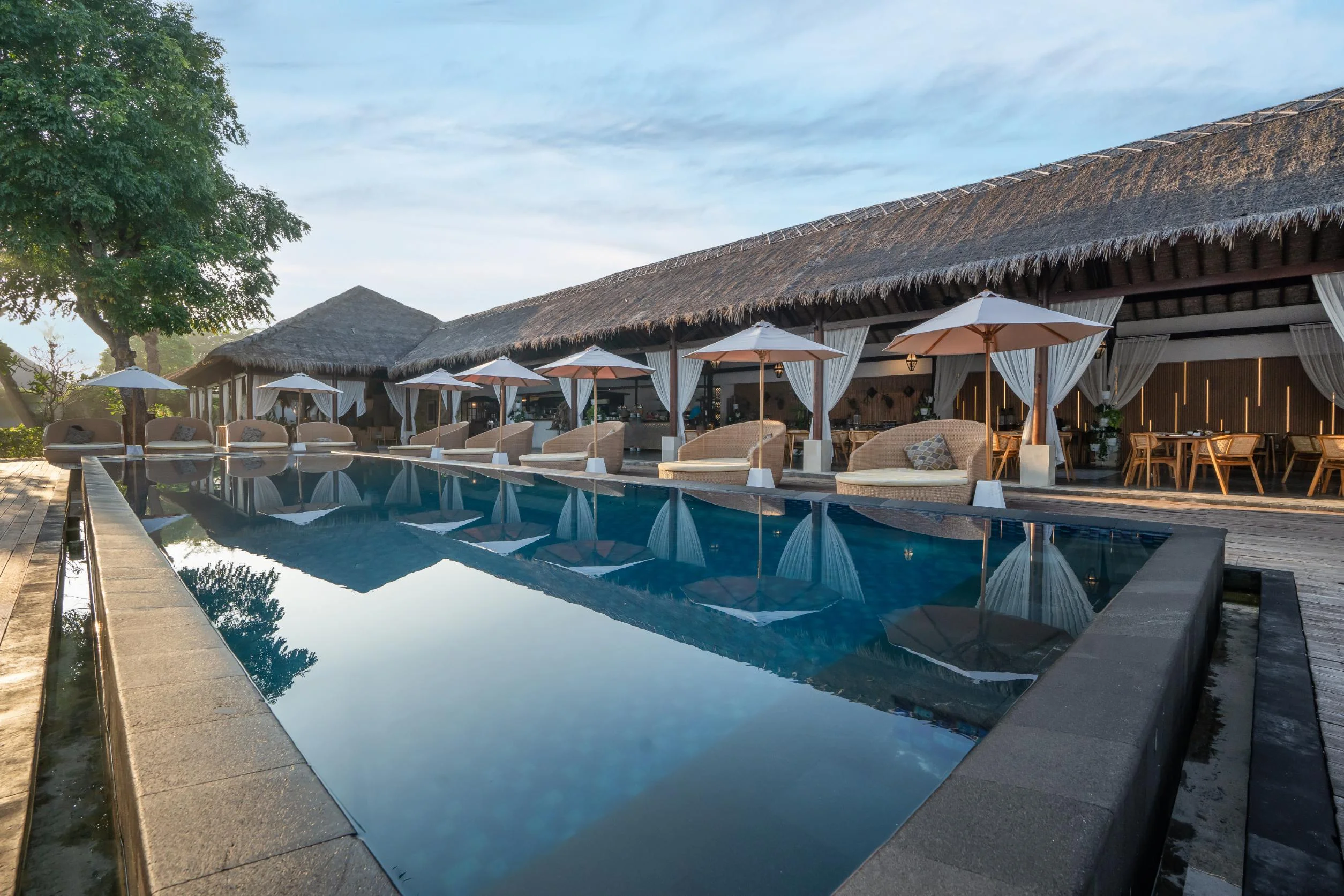Daytime infinity pool and loungers at Lembongan Beach Club & Resort