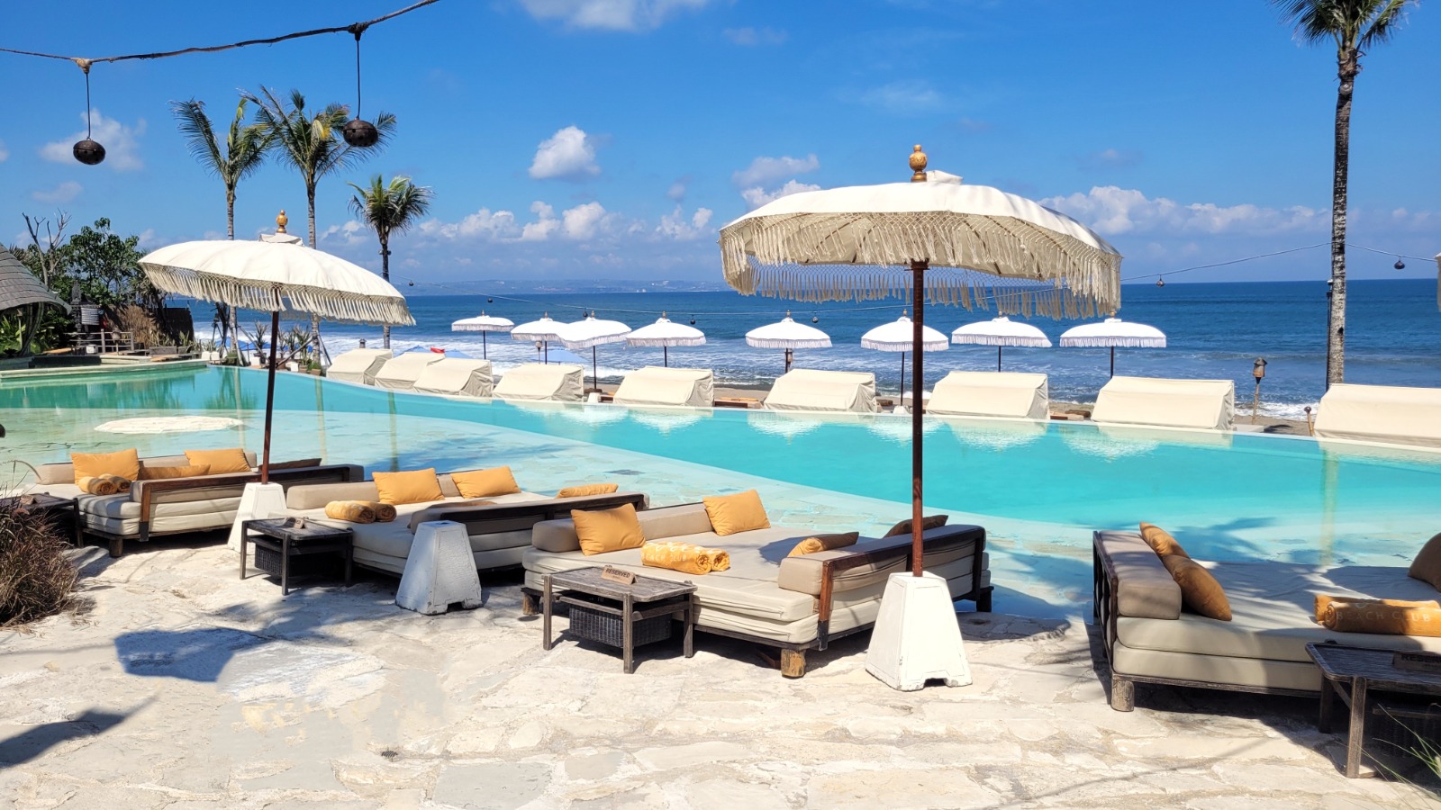 Daytime pool or beach scene at Mari Beach Club.