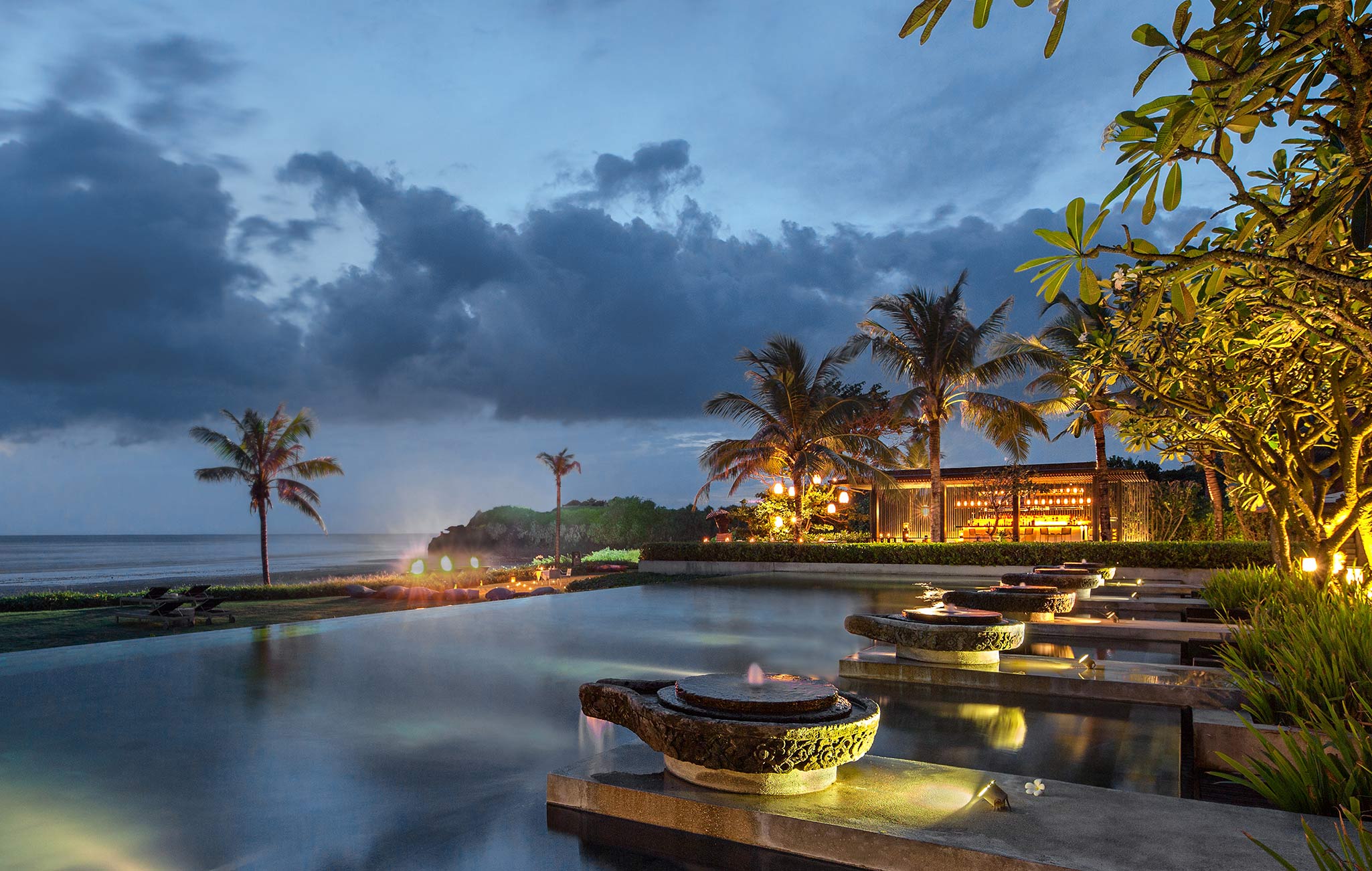 Soori Bali pool, ocean and evening lights near Ombak