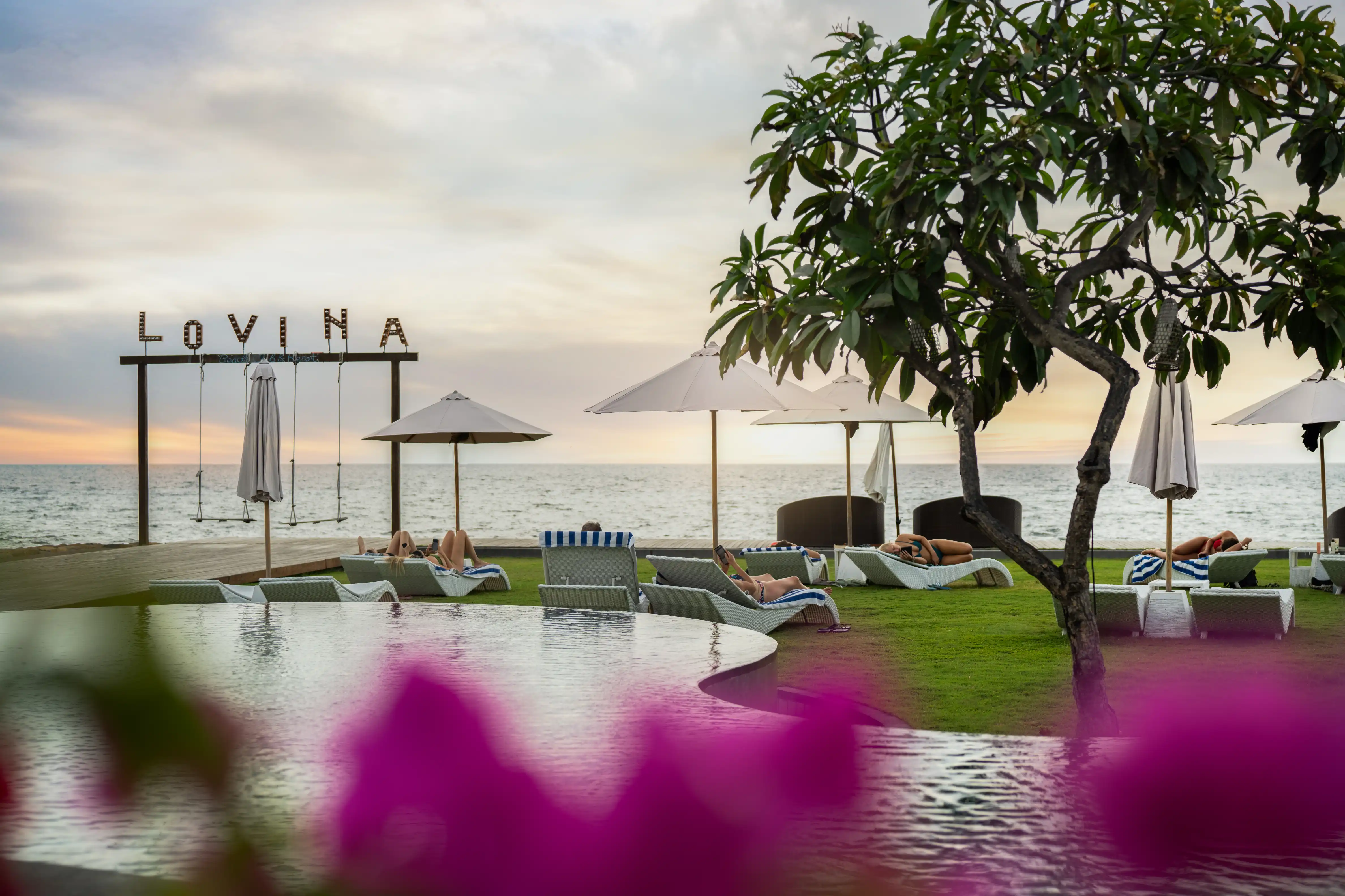 Sea Sky Lovina pool, beachfront lawn and LOVINA sign