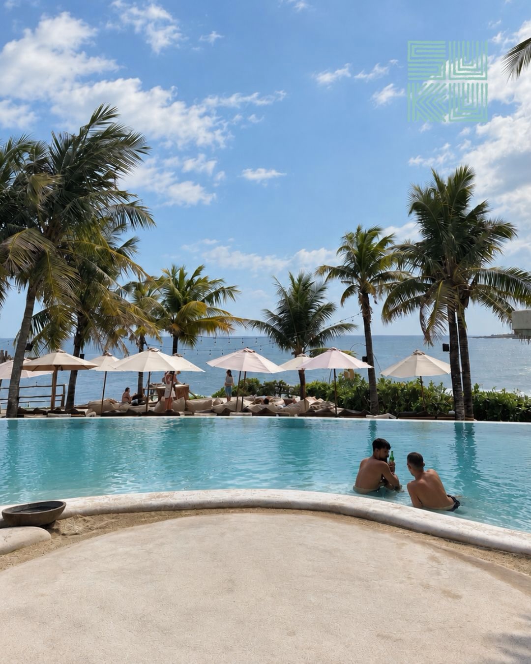 Suku Beach Club — Daytime pool and palms