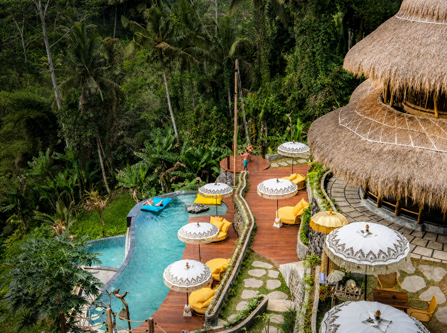 Wide view of the pool, loungers and restaurant at TIS Cafe Ubud