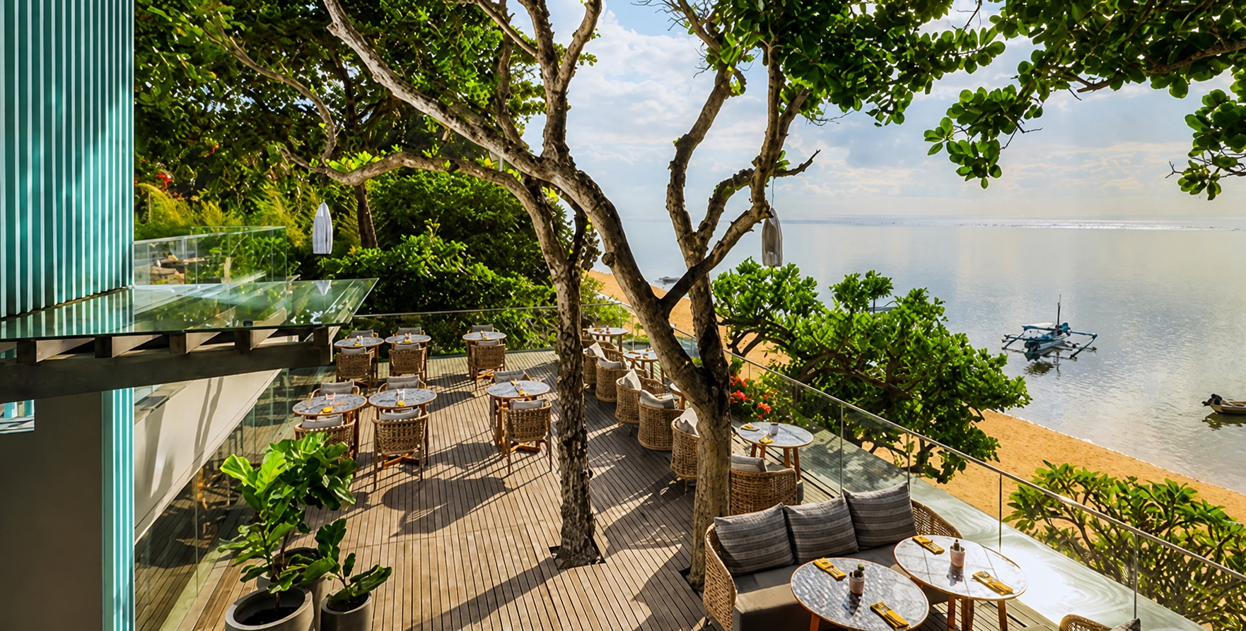 Kursi menghadap laut dan suasana tepi pantai di Tree Bar at Maya Sanur