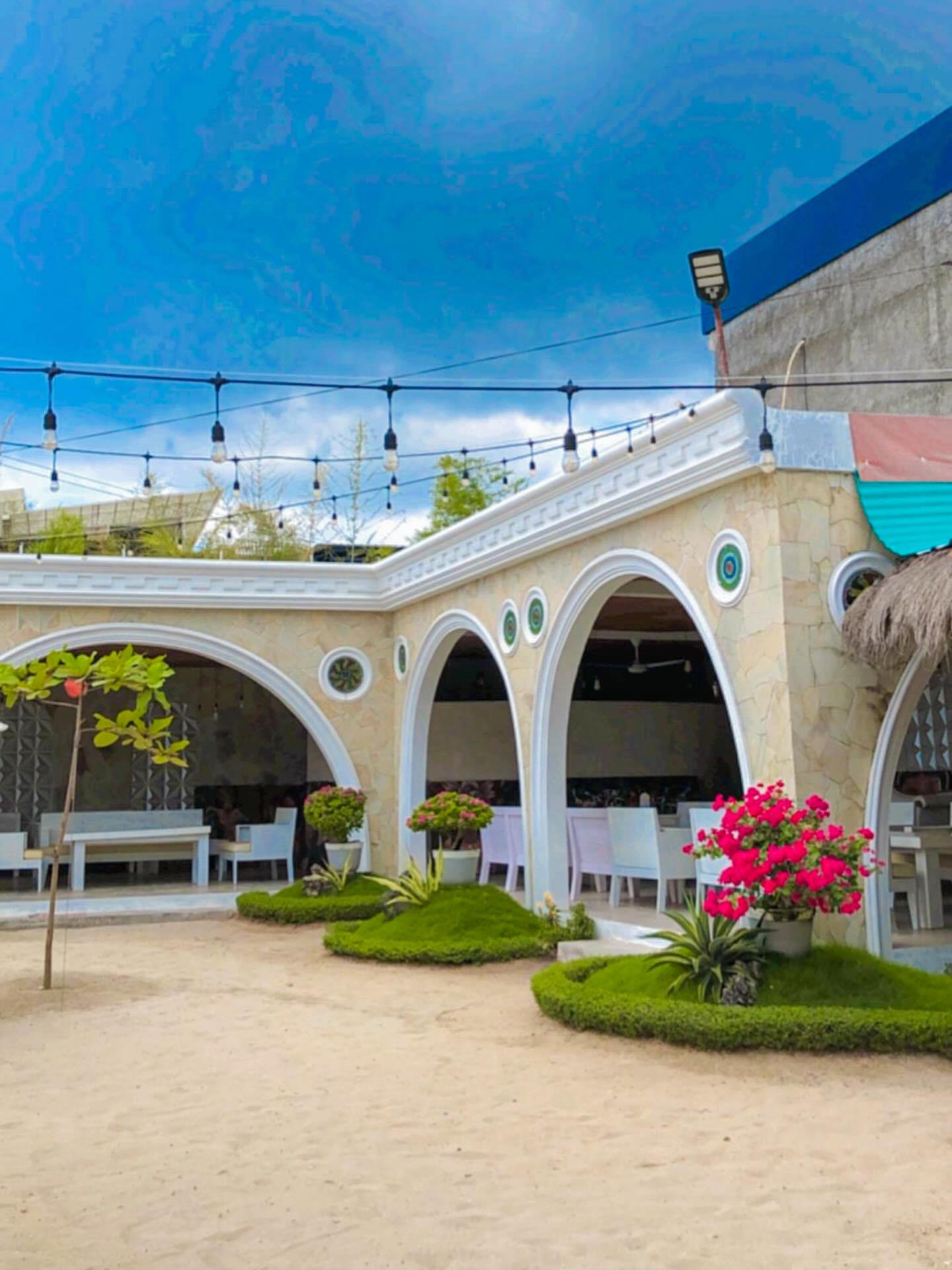 White arches and flowers around the building