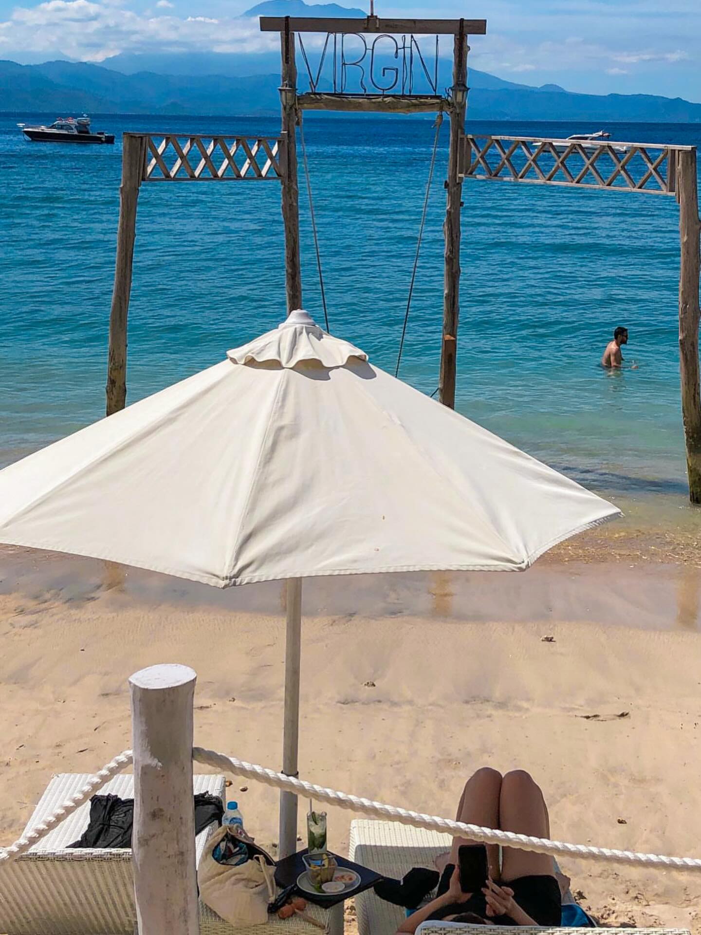 Sea view beyond a white parasol