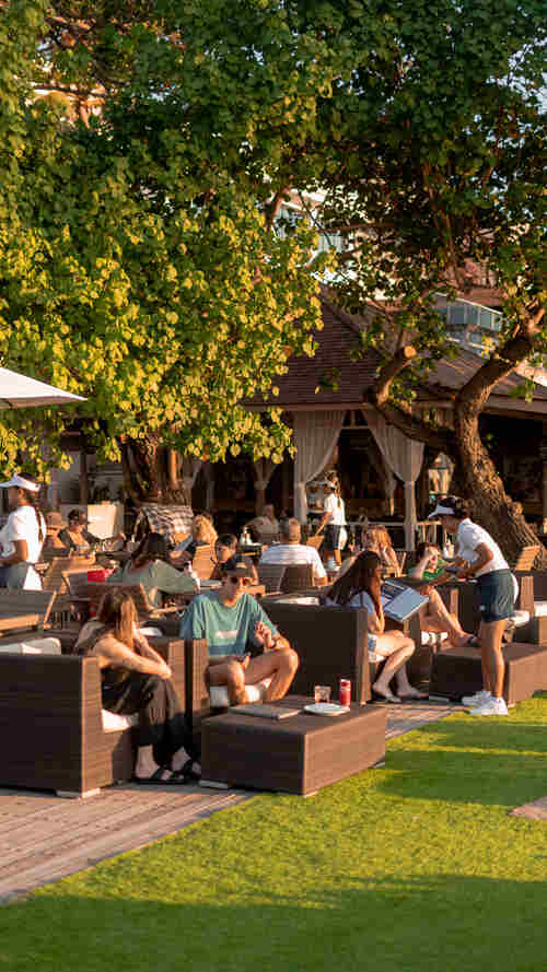 Guests relaxing in Boardwalk's shaded garden seating