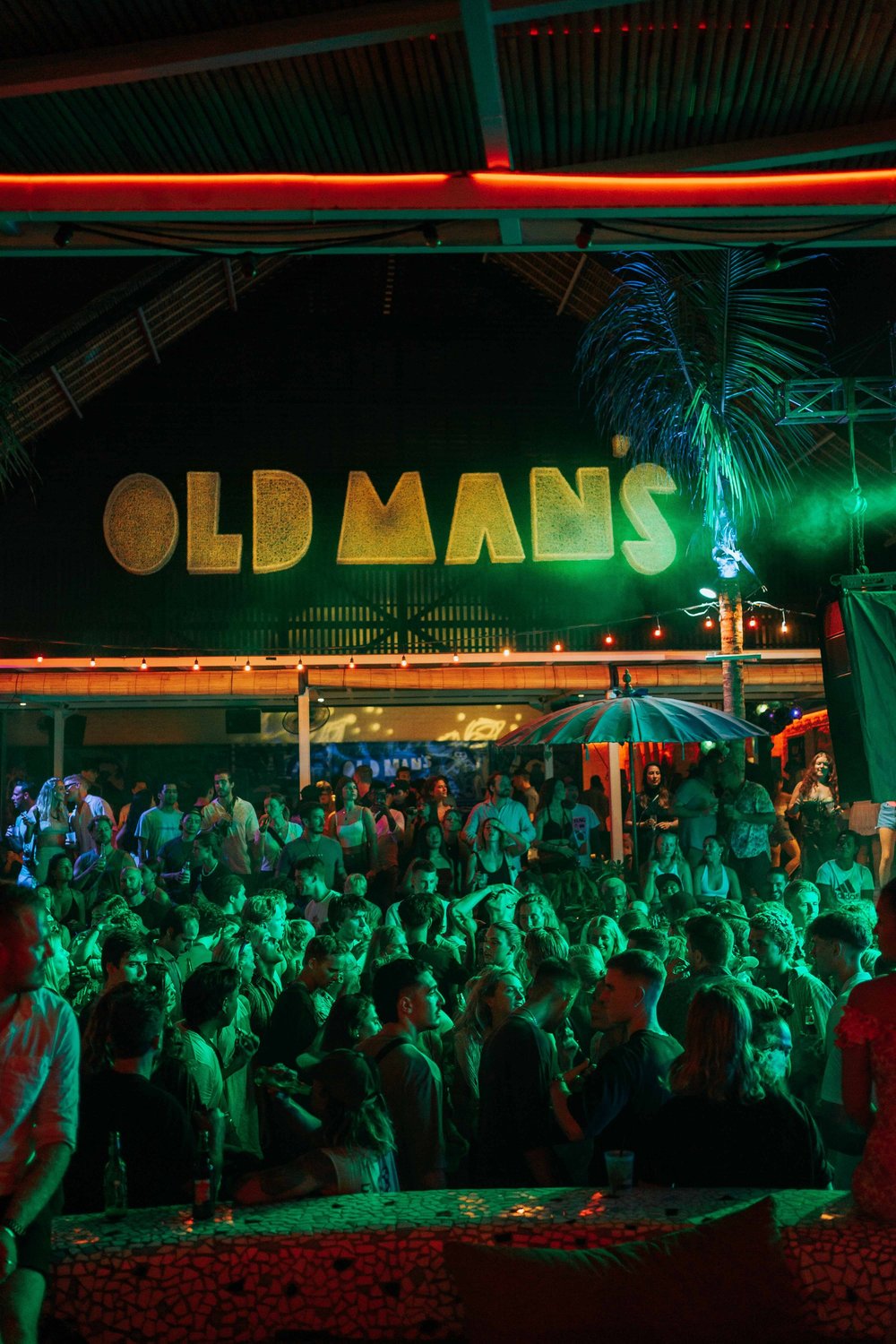 Large Old Man’s sign above the nighttime crowd