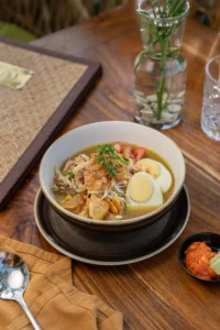 Hidangan mi dengan topping yang disajikan di TIS Cafe Ubud