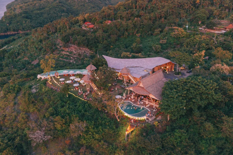 Aerial view of Amok Sunset and its pool at golden hour