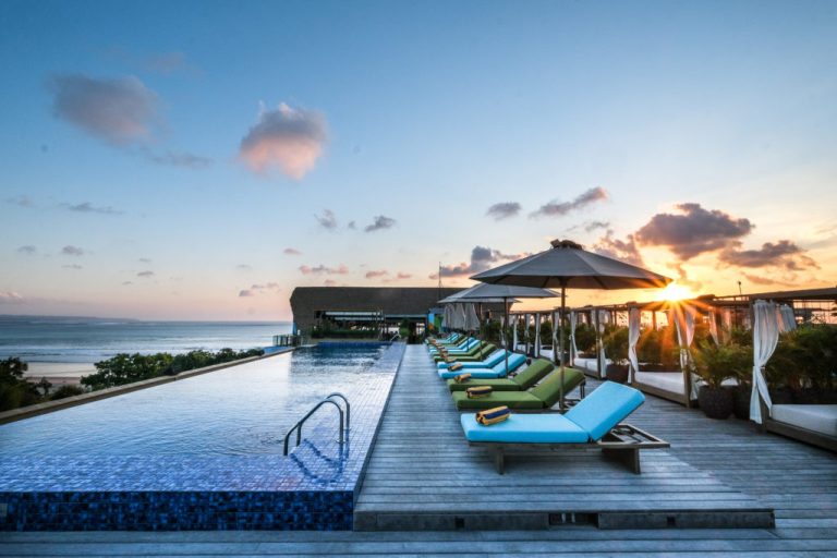 Kuta Social Club rooftop infinity pool and daybeds at sunset