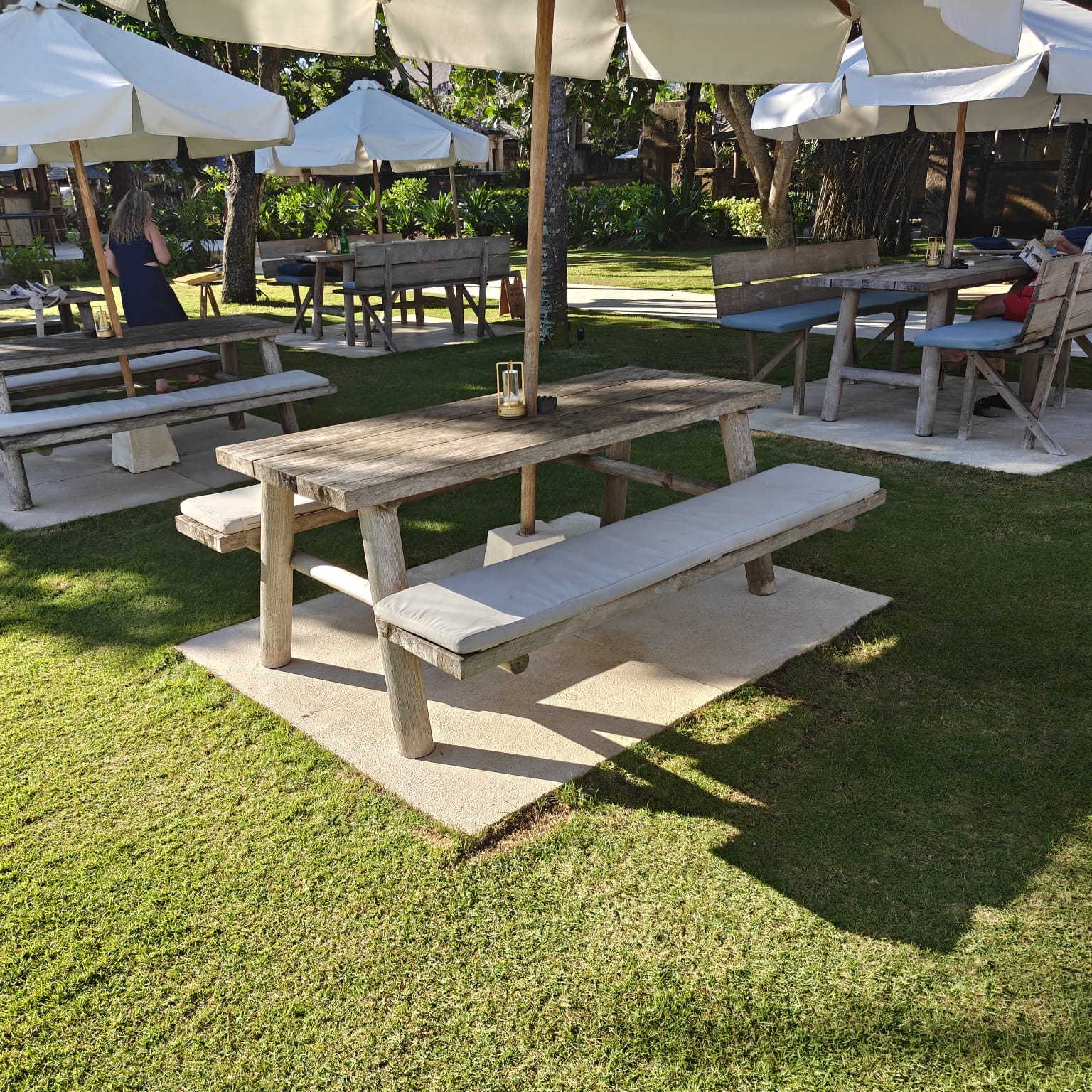 Garden high table seating on the lawn at Suka Sunset Beach Club