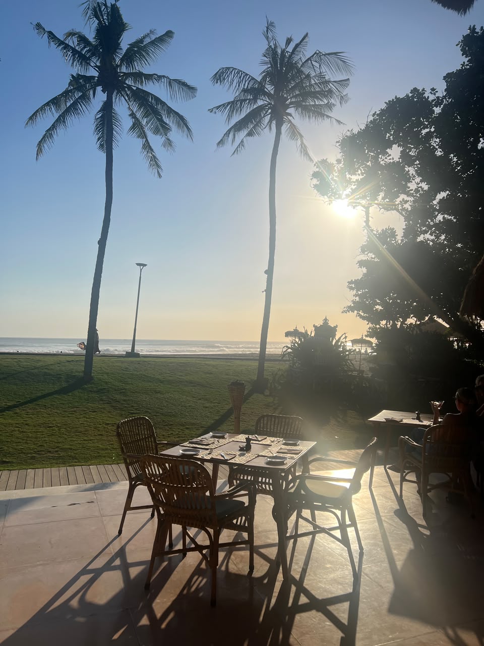 Sunset tables by the beachfront lawn