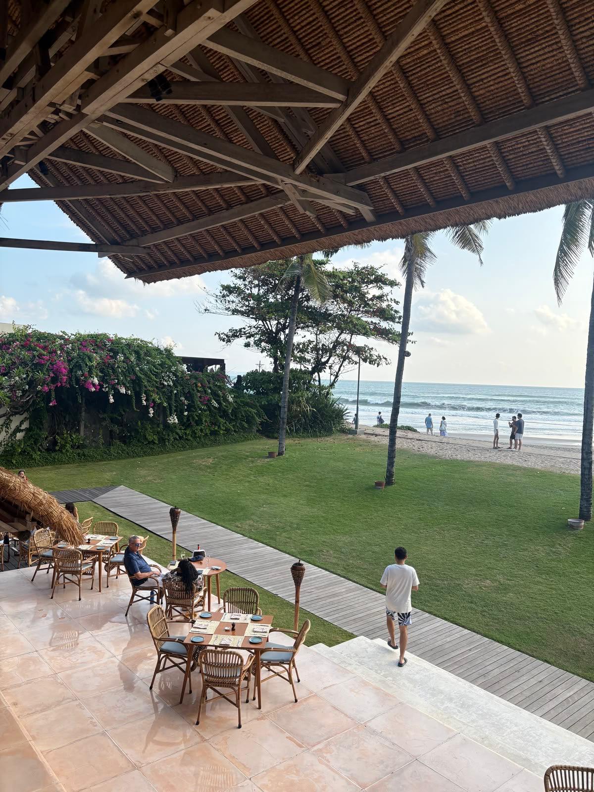 Dining terrace overlooking the beachfront lawn
